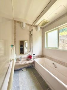 a bathroom with a tub and a sink at Takumisou 2 in Kiso +20 photos