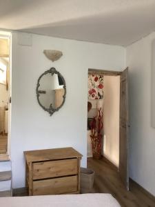 a bedroom with a mirror and a wooden dresser at Alle Fucine in Mallare