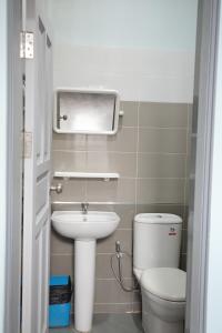 a small bathroom with a toilet and a sink at โรงแรมยุติชัย in Prachuap Khiri Khan +11 photos