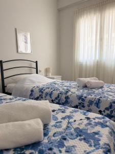 a bedroom with two beds with towels on them at Olivia 42 in Nafpaktos