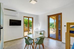 a kitchen and dining room with a table and chairs at Mammina Holiday Home in Casal Velino