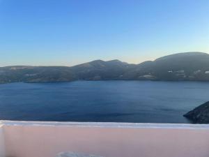 a view of a lake with mountains in the background at The Red-Fish House in Astypalaia