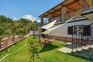 a house with a patio and a balcony at Mammina Holiday Home in Casal Velino
