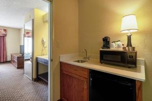 a kitchen with a microwave and a sink in a hotel room at Quality Suites San Antonio Northeast in San Antonio +35 photos