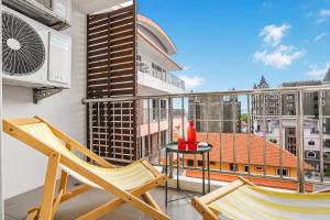 a balcony with two chairs and a table on a building at Luxurious Penthouse Pattaya in Pattaya South
