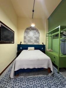 a bedroom with a bed and a green cabinet at Casa MARTINA in Villahermosa