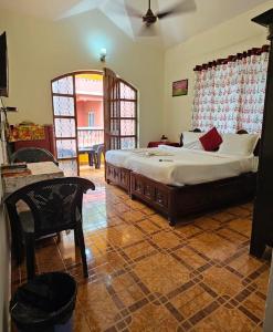 a bedroom with a large bed in a room at Flobestian's Seafront Villa in Candolim
