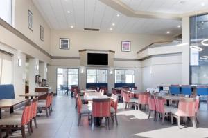 a dining room with tables and chairs at Comfort Inn & Suites Wichita Northeast in Wichita