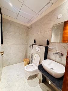 a bathroom with a white toilet and a sink at Hotel janki elite in Jaipur +11 photos