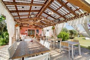 an outdoor patio with a wooden table and chairs at Fattoria I Canarini - Biolago in Fossalta di Piave