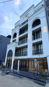 a white building with a gate in front of it at The Koi Boutique Hotel in Gurgaon