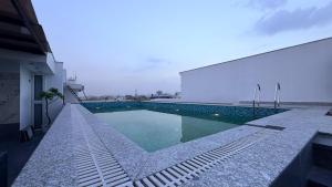 a swimming pool on the side of a building at The Koi Boutique Hotel in Gurgaon