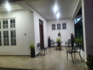 a room with chairs and a table in a building at Dee Holidays - in Moratuwa