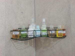 a shelf with many different bottles of liquid at Dee Holidays - in Moratuwa +1 photo