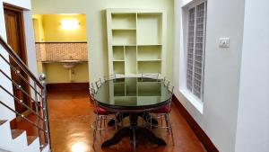 a glass table in the middle of a room at Canorix Inn in Athirappilly