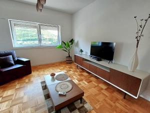 a living room with a couch and a tv at Pinhão House in Pinhão
