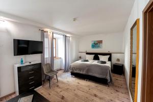 a bedroom with a bed and a flat screen tv at Schloss Hotel Wurzen in Wurzen +57 photos