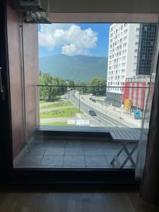 a window in a building with a view of a highway at ilidza sky river 2 in Sarajevo
