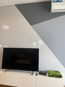 a large flat screen tv on a white wall at ilidza sky river 2 in Sarajevo +6 photos