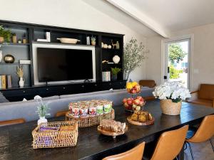 a living room with a table with baskets of food at Fireside Inn on Moonstone Beach in Cambria
