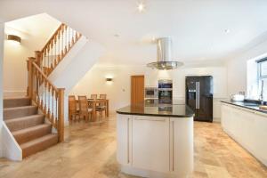 a kitchen and dining room with a staircase in a house at The Old Stables in Bamburgh
