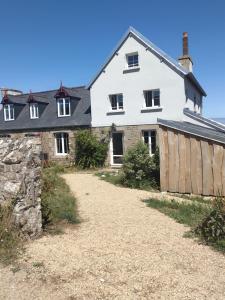 a large white house with a barn at Maison Ciaran in Trébeurden