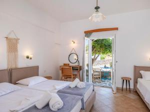 a bedroom with two beds and a table at Akteon Hotel in Logaras