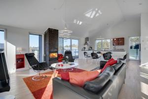 a living room with a couch and a table at Lübker Golf Resort in Nimtofte