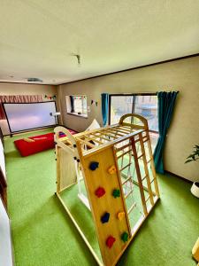 a childrens room with a play room with a ladder at Asobico焼津 in Yaizu