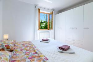 a bedroom with a bed with two towels on it at Miren apartma Ankaran SP - Peaceful Apartment Ankaran SP in Ankaran