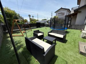a yard with a playground with chairs and a swing at Asobico焼津 in Yaizu