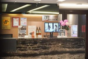 a television on a counter in a store at Talmud Hotel Yizhong in Taichung