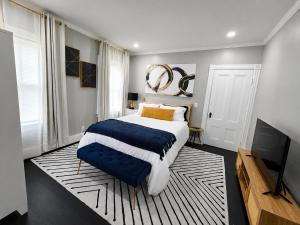 a bedroom with a large bed and a television at Sleeps 6 Near Boston, Providence & Gillette in Attleboro