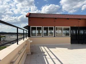 a building with a balcony with a view of the water at Chandran Apartments in Vellore