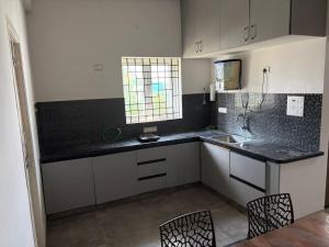a kitchen with a sink and a counter top at Chandran Apartments in Vellore