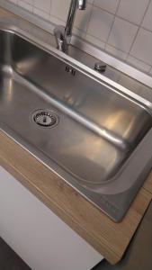 a stainless steel sink in a kitchen at Il Rigoletto Casa Vacanze in Lamezia Terme +18 photos