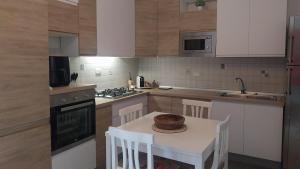 a kitchen with a table with a cake on it at Il Rigoletto Casa Vacanze in Lamezia Terme