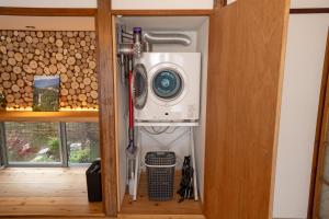 a washer and dryer on a shelf in a room at The Whale House 日光 by Silver Daisy in Nikko