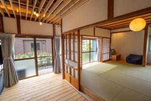 an empty room with a large window in a house at The Whale House 日光 by Silver Daisy in Nikko
