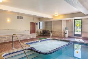 a swimming pool in a hotel room with a pool at Sleep Inn & Suites Bay View Acme - Traverse City in Traverse City