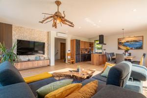 a living room with a couch and a table at Villa Vinita w/ Jacuzzi & Sauna near Thermal Spa - Happy Rentals in Sveti Jurij ob Ščavnici
