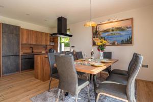 a kitchen and dining room with a wooden table and chairs at Villa Vinita w/ Jacuzzi & Sauna near Thermal Spa - Happy Rentals in Sveti Jurij ob Ščavnici