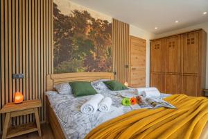 a bedroom with a bed with towels on it at Villa Vinita w/ Jacuzzi & Sauna near Thermal Spa - Happy Rentals in Sveti Jurij ob Ščavnici +34 photos