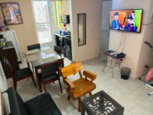 a living room with a television and a table and chairs at Liz in Matehuala