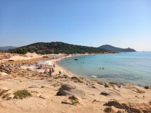 a beach with a bunch of people in the water at Casa Tella in Pula