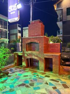 a brick oven in a yard with a building at Cottage 505 in Ureki