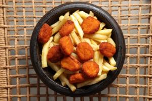 a bowl of food with french fries and nuggets at Nikiforos Village in Hanioti +42 photos