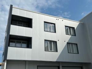 a white building with windows on the side of it at Хотел КО НИ КО in Stara Zagora