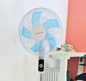 a white fan sitting next to a desk at Cottage de Vardes in Neufmarché