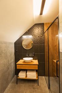 a bathroom with a sink and a mirror at Apartament Wendigo - butikowy, 2-poziomowy, blisko jeziora in Szczecinek +69 photos